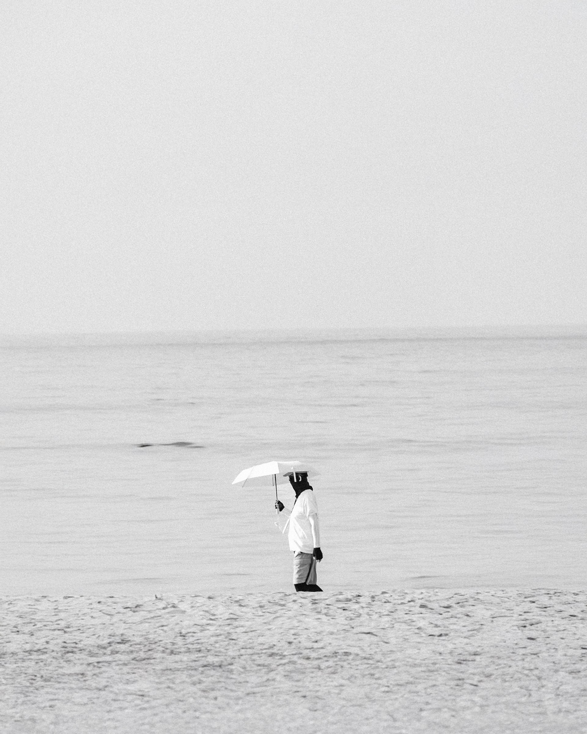 Photograph of a solitary figure from the No One Is Watching series by Mo Badawi